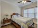 Cozy bedroom with a wooden bed frame, decorative lamp on the nightstand, and a large window at 3002 Portico Pl, Tega Cay, SC 29708