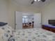 Bright bedroom with a seashell themed bedspread and doorway leading to dining and living areas at 3002 Portico Pl, Tega Cay, SC 29708