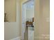 Hallway view leading to a bedroom with a wooden nightstand and a decorative cat figurine on a shelf at 3002 Portico Pl, Tega Cay, SC 29708