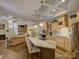 Open concept kitchen and living room with a marble island, stainless appliances, and a cozy fireplace at 3002 Portico Pl, Tega Cay, SC 29708