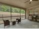 Screened patio with ceiling fan and an outdoor seating area with wicker furniture at 3002 Portico Pl, Tega Cay, SC 29708