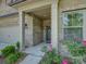 Charming covered porch entrance with detailed brickwork and lovely rose bushes at 3002 Portico Pl, Tega Cay, SC 29708