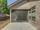Covered screened porch adjacent to the house with a gray frame, window, and concrete flooring at 3002 Portico Pl, Tega Cay, SC 29708