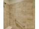 Tiled shower featuring a safety bar, a shower head, and a corner shelf at 3002 Portico Pl, Tega Cay, SC 29708