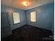 This simple bedroom features two windows and a large entry door at 315 Broad Sw Dr, Concord, NC 28025