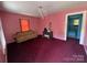 Bright living room featuring pink walls with colorful vintage sofa and a view of the bathroom at 315 Broad Sw Dr, Concord, NC 28025