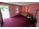 A living room with pink walls with vintage furniture at 315 Broad Sw Dr, Concord, NC 28025
