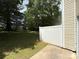 Fenced backyard with lush green grass and mature trees at 3527 Creeping Flora Ln, Charlotte, NC 28216