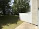 A spacious backyard with a concrete patio, enclosed by a white privacy fence at 3527 Creeping Flora Ln, Charlotte, NC 28216