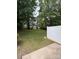 A large, tree-filled backyard with a privacy fence at 3527 Creeping Flora Ln, Charlotte, NC 28216