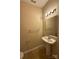 Well-lit bathroom with a pedestal sink, neutral walls, and tile flooring at 3527 Creeping Flora Ln, Charlotte, NC 28216