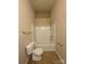 Bathroom offers toilet and bathtub with shower, all in clean, neutral tones at 3527 Creeping Flora Ln, Charlotte, NC 28216