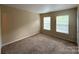 Carpeted bedroom with dual windows and neutral decor for personalized design at 3527 Creeping Flora Ln, Charlotte, NC 28216