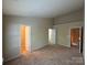 Large bedroom with carpet floor, neutral walls, and access to walk-in closet at 3527 Creeping Flora Ln, Charlotte, NC 28216
