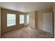 This bedroom has large windows, carpet floor, and neutral walls at 3527 Creeping Flora Ln, Charlotte, NC 28216