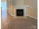 Close-up of a stylish fireplace with tiled hearth and mantel, seamlessly blending carpet and tile flooring at 3527 Creeping Flora Ln, Charlotte, NC 28216