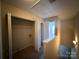 Hallway featuring a utility closet, an open doorway, and doorways leading to additional rooms or spaces at 3527 Creeping Flora Ln, Charlotte, NC 28216