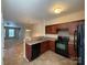 Well-appointed kitchen featuring tile floors, wood cabinets, modern appliances, and a practical layout for cooking and dining at 3527 Creeping Flora Ln, Charlotte, NC 28216