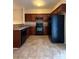 Well-lit kitchen featuring ample counter space and dark wood cabinets at 3527 Creeping Flora Ln, Charlotte, NC 28216