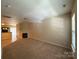 Spacious living area with neutral walls, plush carpeting, a fireplace, and natural light creates a warm and inviting atmosphere at 3527 Creeping Flora Ln, Charlotte, NC 28216
