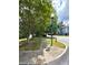 A quiet residential street corner with mature trees and a street sign at 3527 Creeping Flora Ln, Charlotte, NC 28216