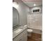Bright bathroom features vanity, granite countertop, mirror, toilet, and tub with shower combo at 404 N Peterson St, Stanley, NC 28164