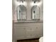 Beautiful bathroom featuring double vanity, granite countertop, stylish mirrors and modern lighting fixtures at 404 N Peterson St, Stanley, NC 28164
