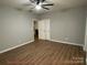 Large bedroom with wood-look flooring and ample natural light at 404 N Peterson St, Stanley, NC 28164