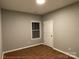 Cozy bedroom with natural light, closet, warm wood-look flooring, and neutral paint at 404 N Peterson St, Stanley, NC 28164