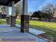 Covered front porch with brick pillars and view of the street at 404 N Peterson St, Stanley, NC 28164