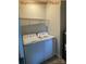 Well-equipped laundry room with modern washer, dryer, wire rack, and ample space for convenience at 404 N Peterson St, Stanley, NC 28164