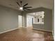 Open-concept living room features hardwood floors and a ceiling fan at 404 N Peterson St, Stanley, NC 28164