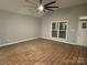 Bright living room with large windows and a modern ceiling fan at 404 N Peterson St, Stanley, NC 28164