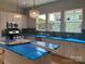 Bright kitchen features white cabinets, blue tile backsplash, and a large island with blue countertop at 408 Nathaniel Way # Brx0053, Charlotte, NC 28213