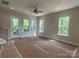 Bright open-concept living room with large windows and a sliding glass door to the balcony at 408 Nathaniel Way # Brx0053, Charlotte, NC 28213