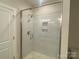 Shower features frameless glass door and marble-style tile with built-in niche at 408 Nathaniel Way # Brx0053, Charlotte, NC 28213
