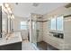 Modern bathroom features a glass shower with gray tiling, double sink vanity, and mosaic tile accents at 430 Edgegreen Dr, Charlotte, NC 28217
