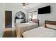 Bedroom with twin beds featuring natural lighting, TV, and adjacent entry door at 430 Edgegreen Dr, Charlotte, NC 28217