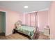 Bedroom painted in pink providing a cozy and calming space with hardwood floors and natural light at 430 Edgegreen Dr, Charlotte, NC 28217
