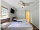Bedroom with twin beds featuring a ceiling fan, window views, and ensuite bathroom access at 430 Edgegreen Dr, Charlotte, NC 28217