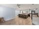 Modern kitchen featuring an island with seating, stainless steel appliances, and wood floors open to the living room at 430 Edgegreen Dr, Charlotte, NC 28217