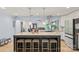 Spacious kitchen island with seating, stainless steel appliances, and pendant lighting creates a warm and inviting culinary space at 430 Edgegreen Dr, Charlotte, NC 28217