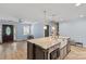 Kitchen area featuring an island with a sink and stainless steel appliances with wood floors that opens to living area at 430 Edgegreen Dr, Charlotte, NC 28217