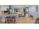 Beautiful kitchen with stainless steel appliances, an island and sink, hardwood floors, and view to living area at 430 Edgegreen Dr, Charlotte, NC 28217