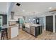 Spacious kitchen with stainless steel appliances, an island, hardwood floors, and views into multiple rooms at 430 Edgegreen Dr, Charlotte, NC 28217