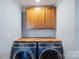 Laundry room featuring front load washer and dryer with herringbone patterned countertop at 430 Edgegreen Dr, Charlotte, NC 28217