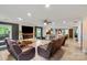 Spacious living room with stone fireplace, wood floors, an open view to the kitchen, and comfortable furniture at 430 Edgegreen Dr, Charlotte, NC 28217
