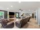 Spacious living room with a stone fireplace, hardwood floors, and plentiful natural light and open to the kitchen at 430 Edgegreen Dr, Charlotte, NC 28217