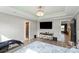 Spacious main bedroom with trey ceiling, recessed lights, TV, and nearby entries to closet and adjacent room at 430 Edgegreen Dr, Charlotte, NC 28217