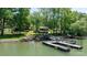 Picturesque lakefront property with a home, dock, and serene water views surrounded by trees at 4599 B & C Dr, Catawba, NC 28609